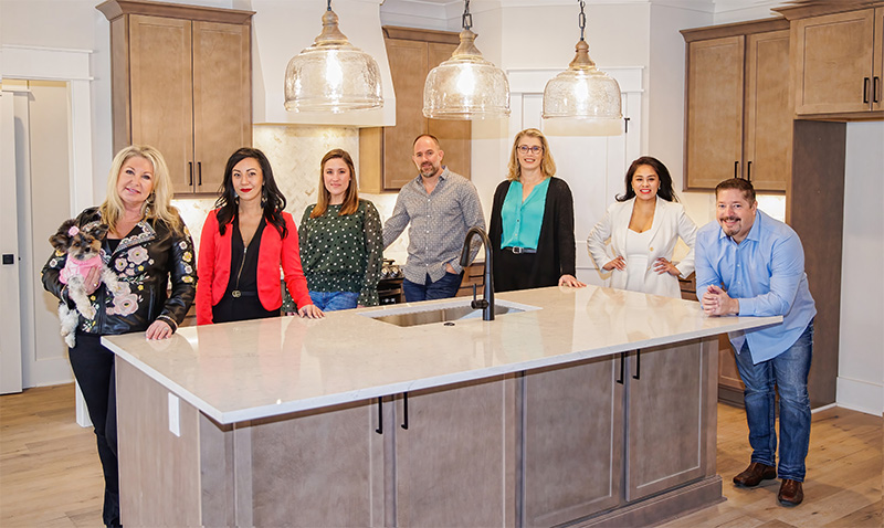 Homepage ctas – home #1, #3, #4 (mobile) Team wommack standing in a kitchen